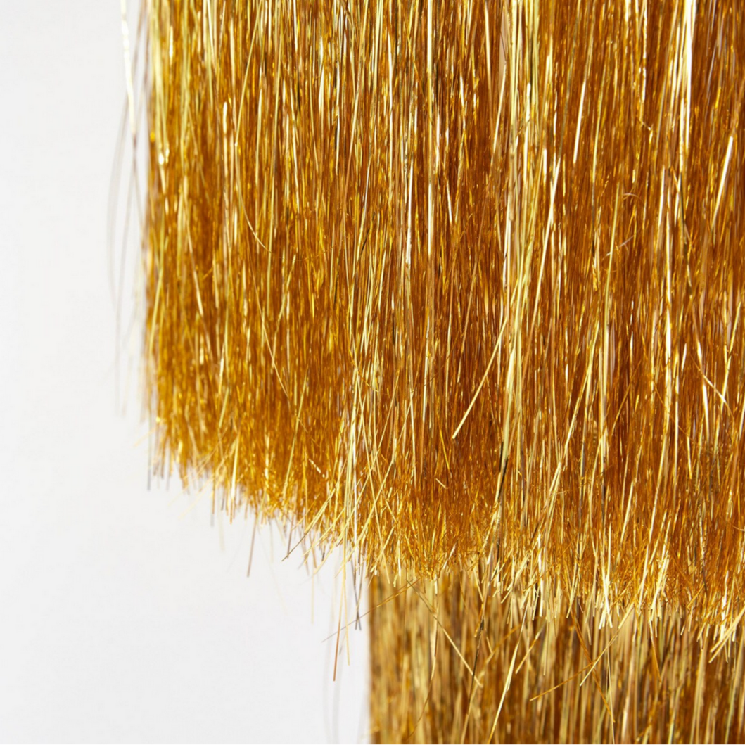 Close-up of gold hair color swatch on a white background