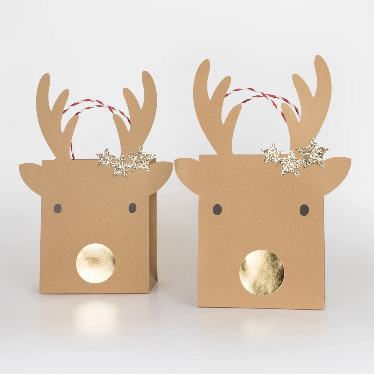 Two brown paper reindeer boxes with antlers and snowflake decorations on a white background