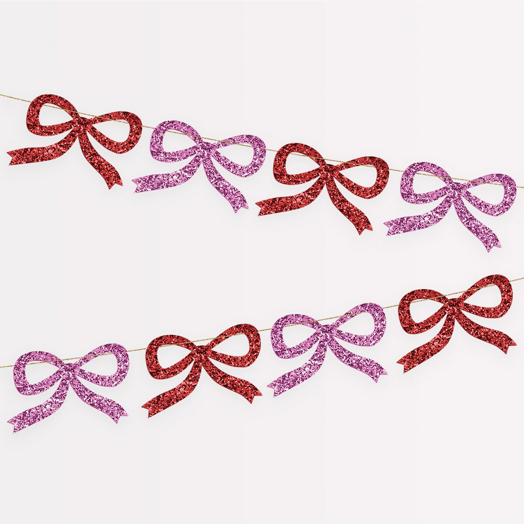 Bunting with red and pink glittery bows on a white background