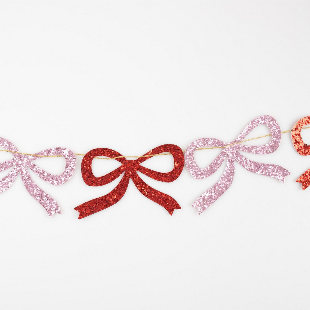 Decorative garland with glittery bows on a white background
