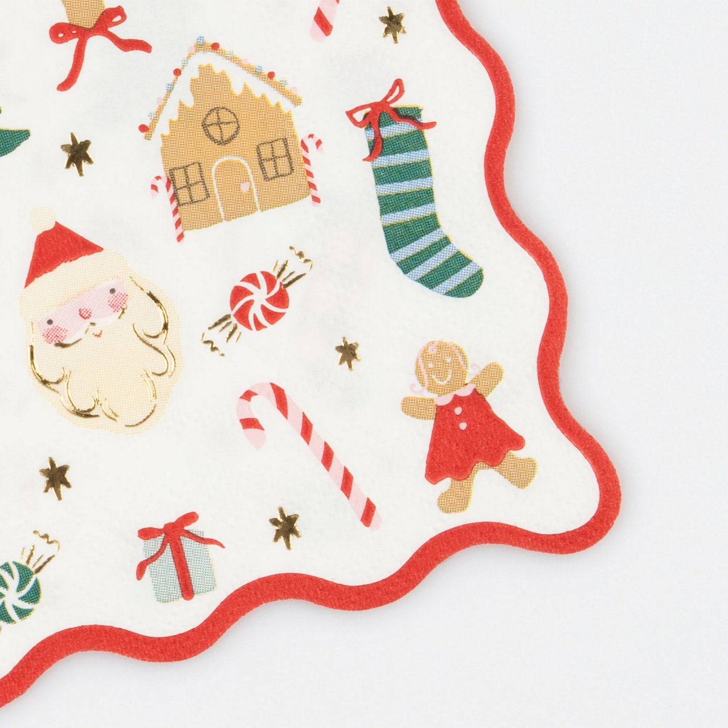 Decorative Christmas-themed napkin with Santa Claus, gingerbread house, candy cane, and other festive elements on a white background.