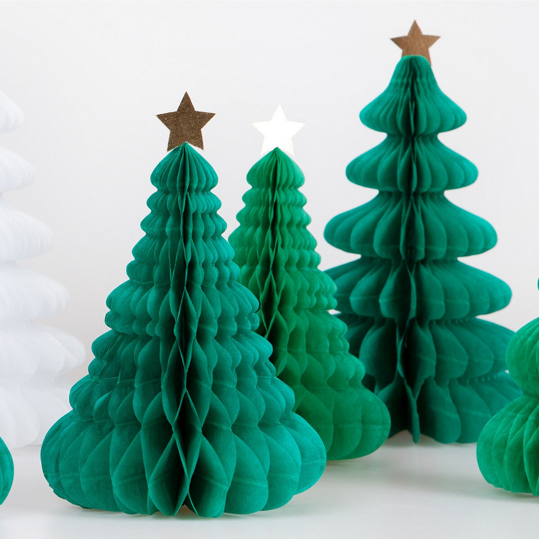 Green paper Christmas trees with star toppers on a white background
