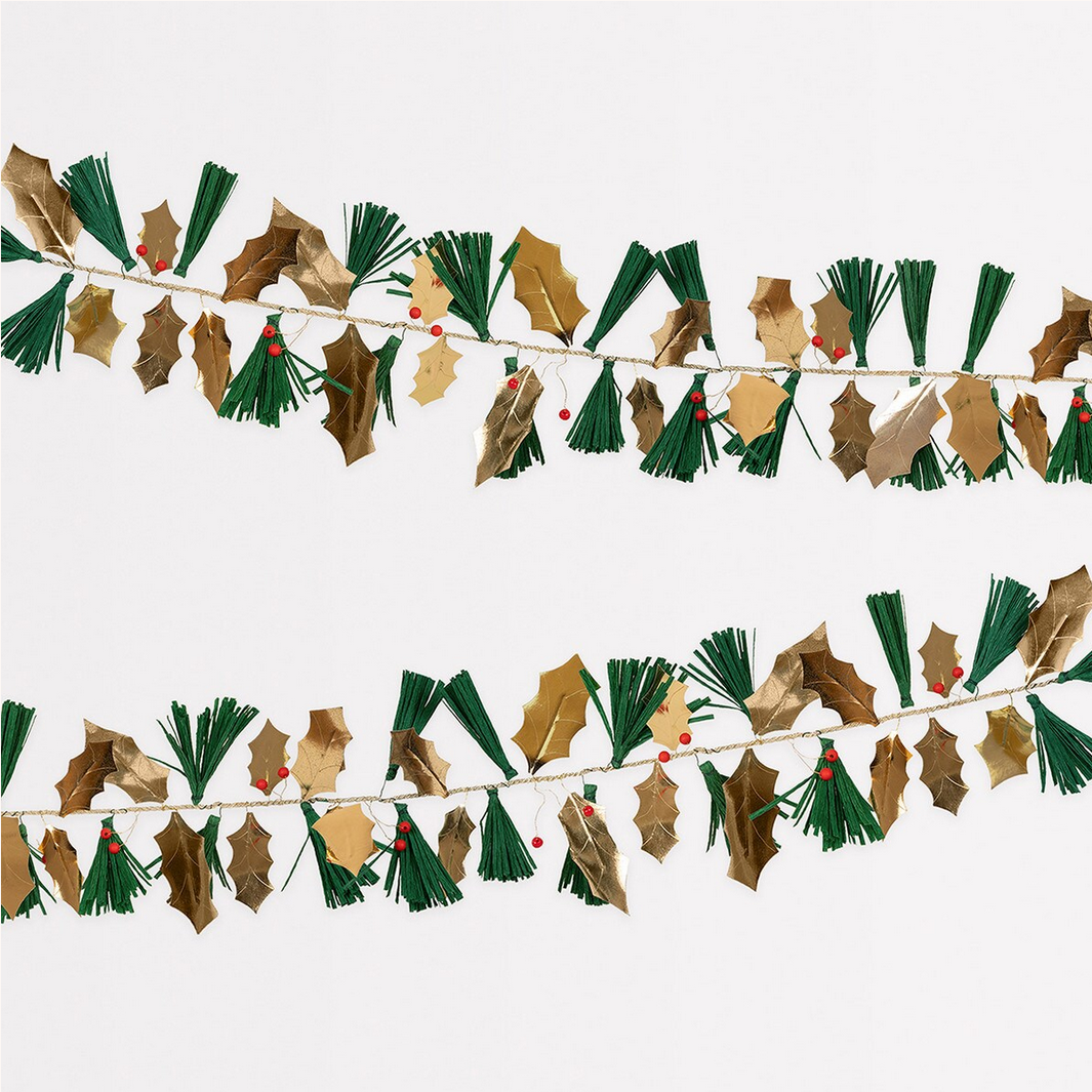 Decorative garland with holly leaves and berries on a white background