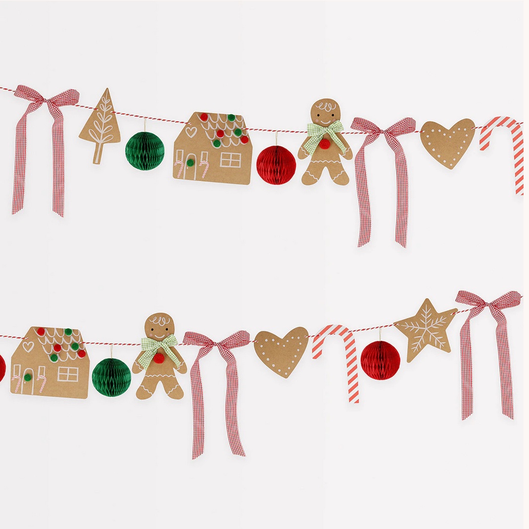 Decorative Christmas garland with gingerbread men, houses, and ribbons on a white background