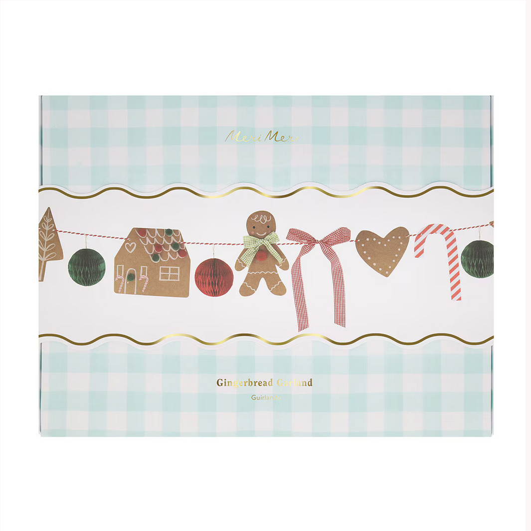 Packaging for 'Gingerbread Land' with gingerbread men, houses, and a bow on a checkered background.