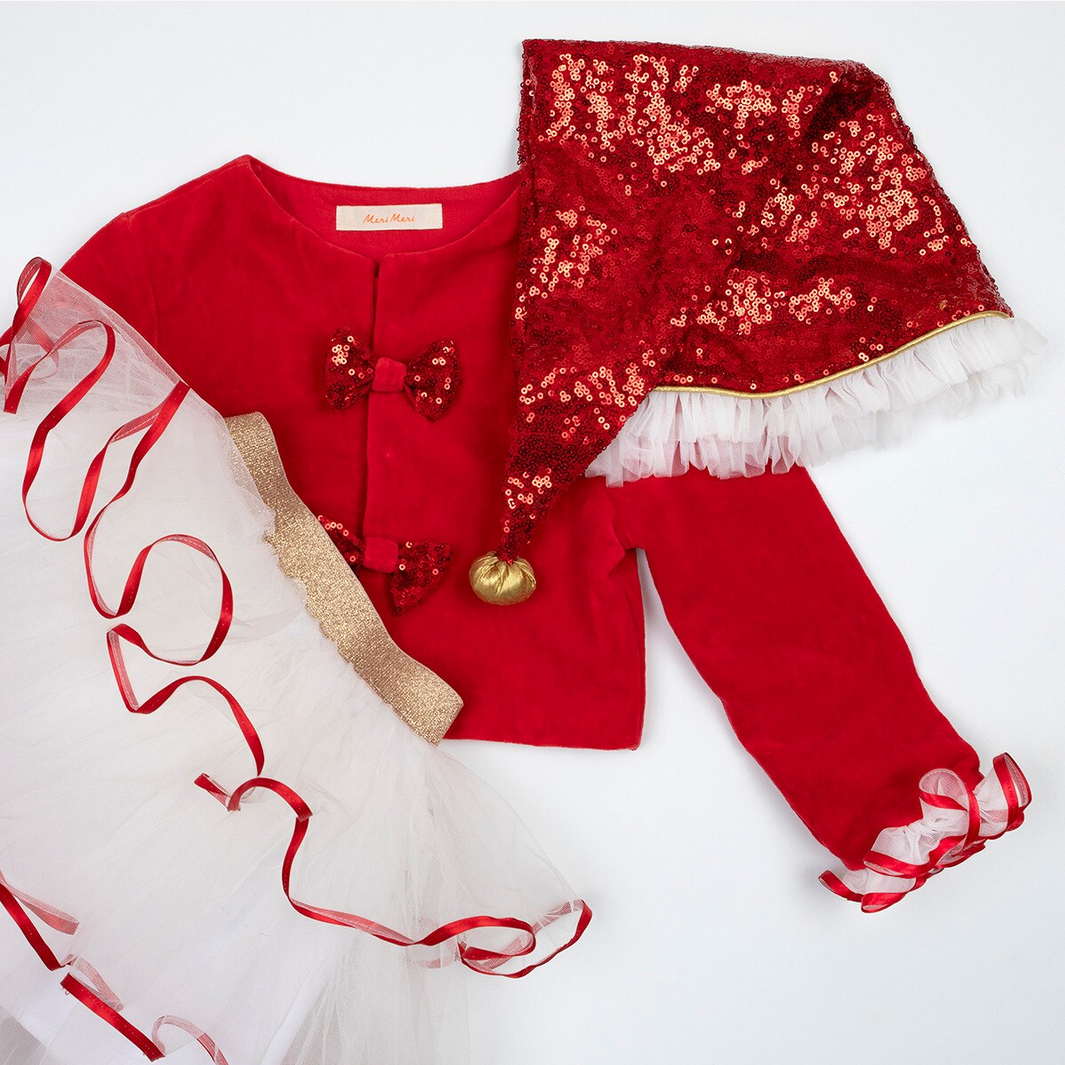 Red children's outfit with sequin details on a white background