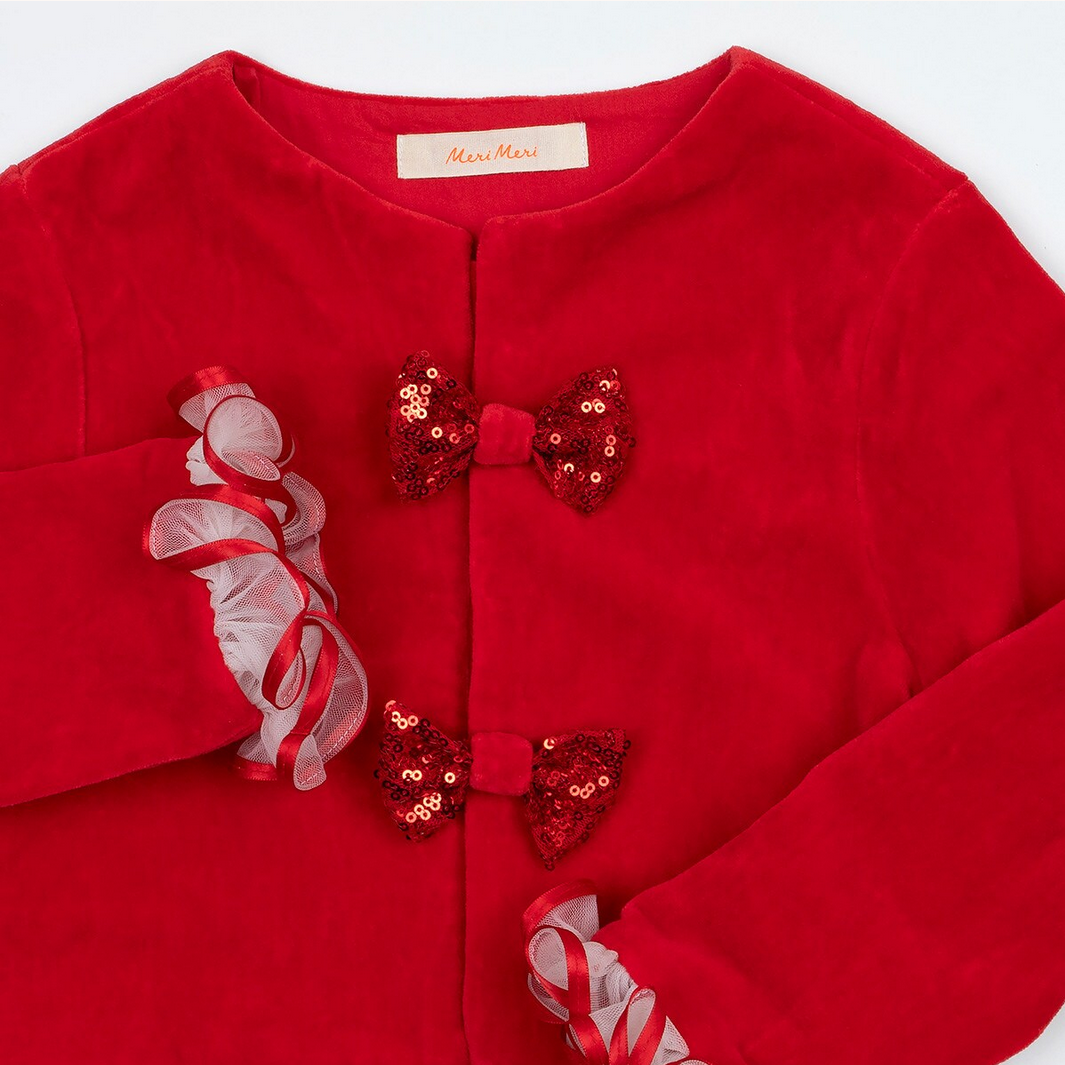 Red velvet dress with sequin bow details on a white background