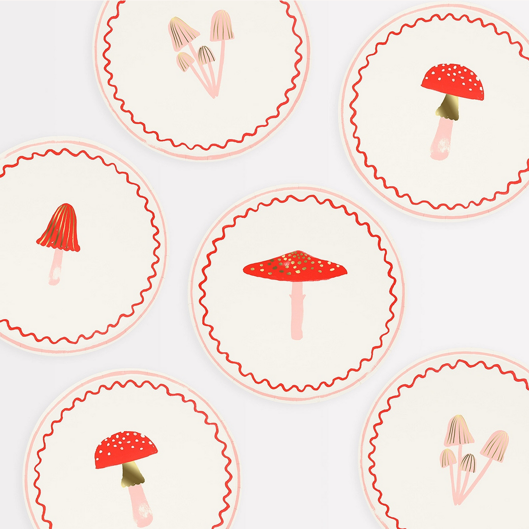 Decorative plates with red mushroom designs on a white background