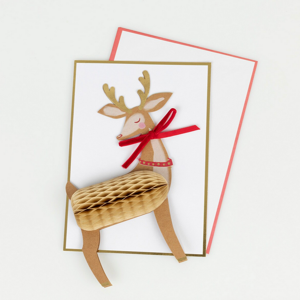 Card with a 3D reindeer design and red bow on a white background