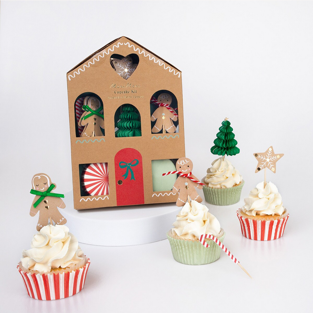 Gingerbread-themed cupcake kit with decorative cupcakes on a white background