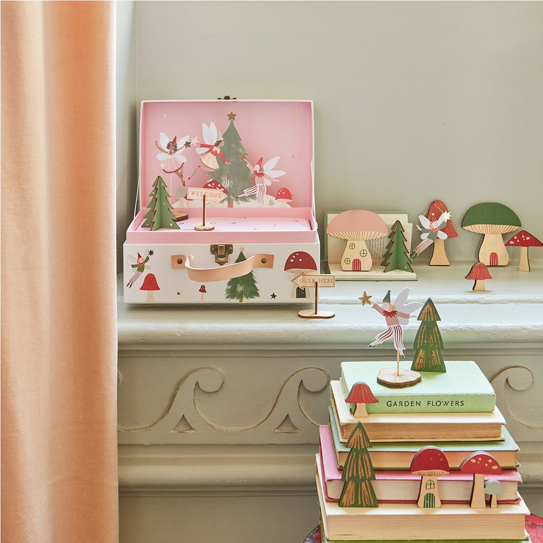 Wooden fairy tale toys with a pink jewelry box on a decorative shelf.