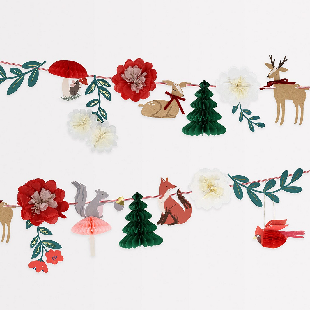 Woodland-themed paper garland with animals and flowers on a white background