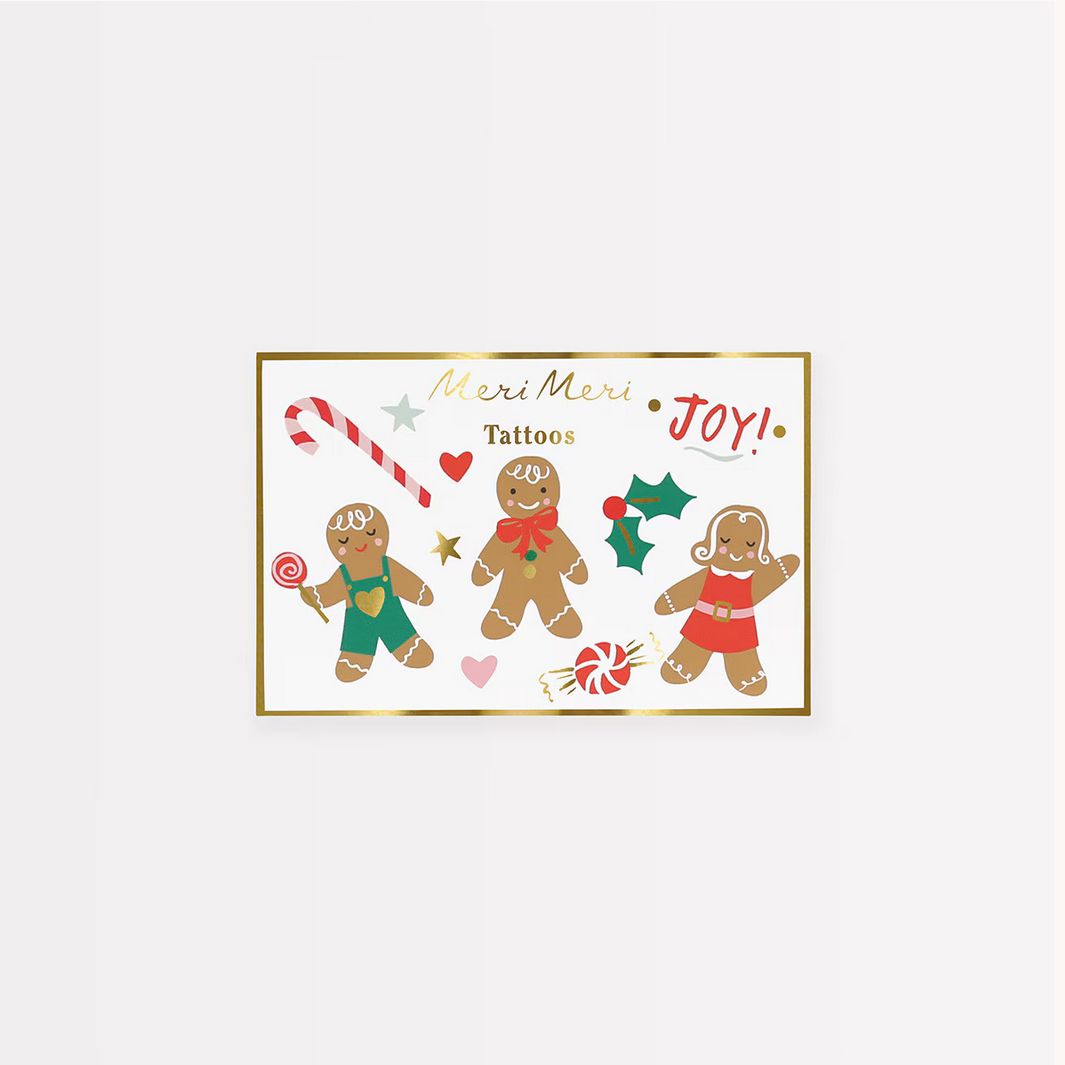 Packaging for Meri Meri tattoos featuring gingerbread men and Christmas elements on a white background.