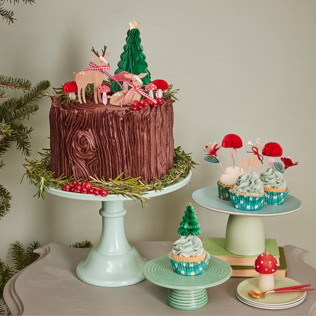 Decorative cake with Christmas-themed decorations on a table with a neutral background