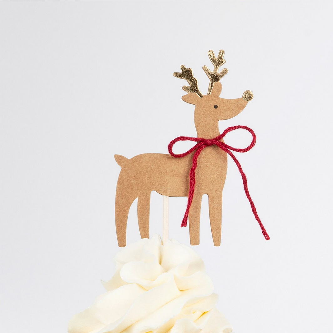 Cardboard reindeer decoration with a red bow on a white background