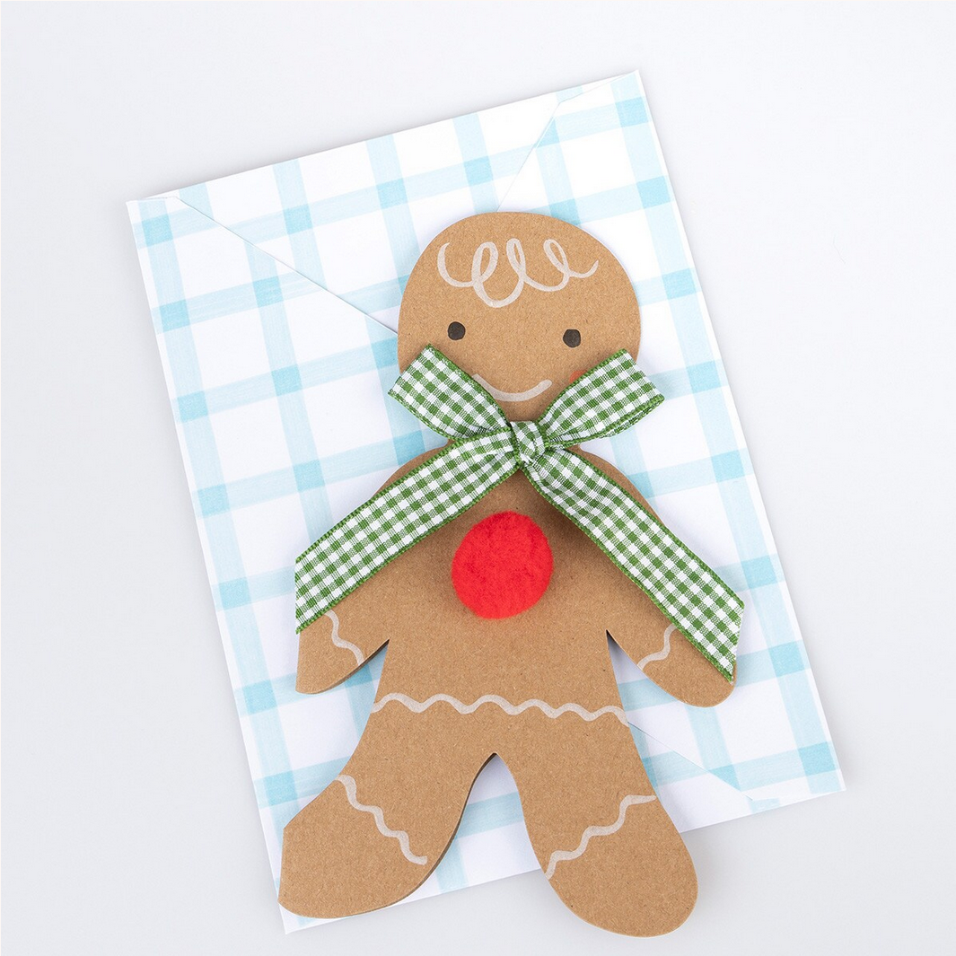Gingerbread man decoration with a green bow on a checkered background