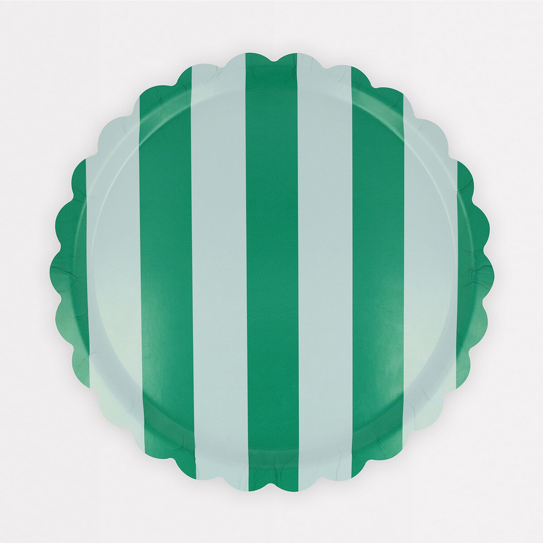 Decorative plate with green and white vertical stripes on a white background