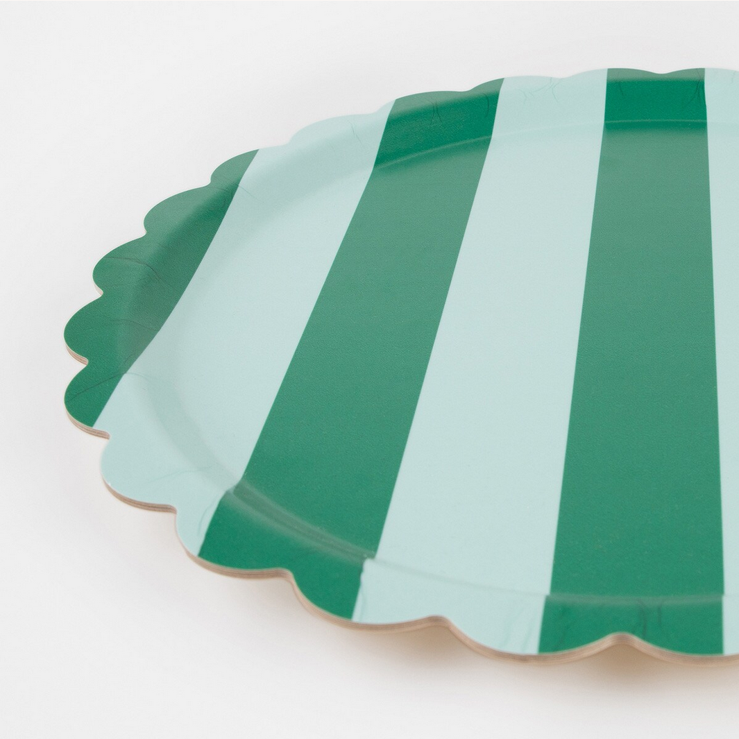 Green and white striped paper plate on a white background