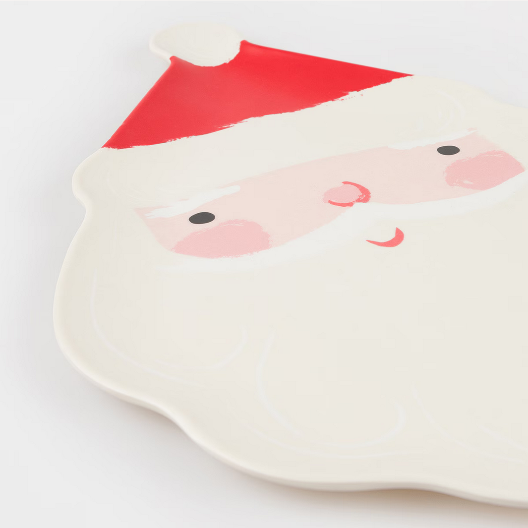 Ceramic plate with a Santa Claus face design on a white background