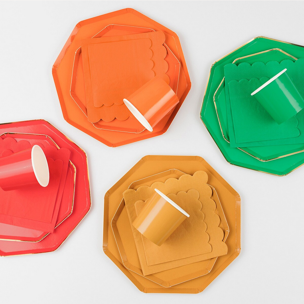 Colorful paper plates and cups on a white background
