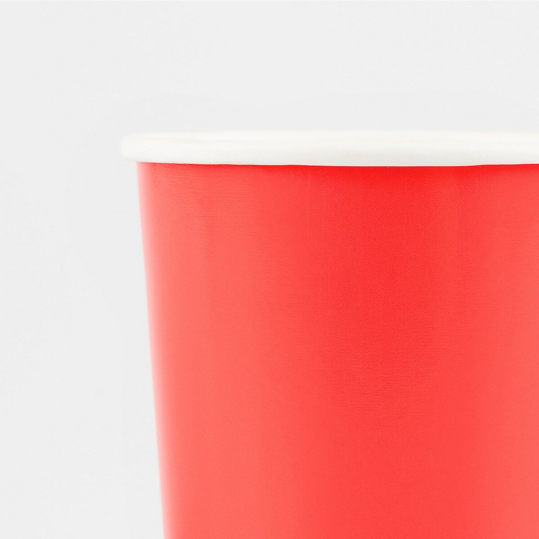Close-up of a red cup with a white rim on a light gray background
