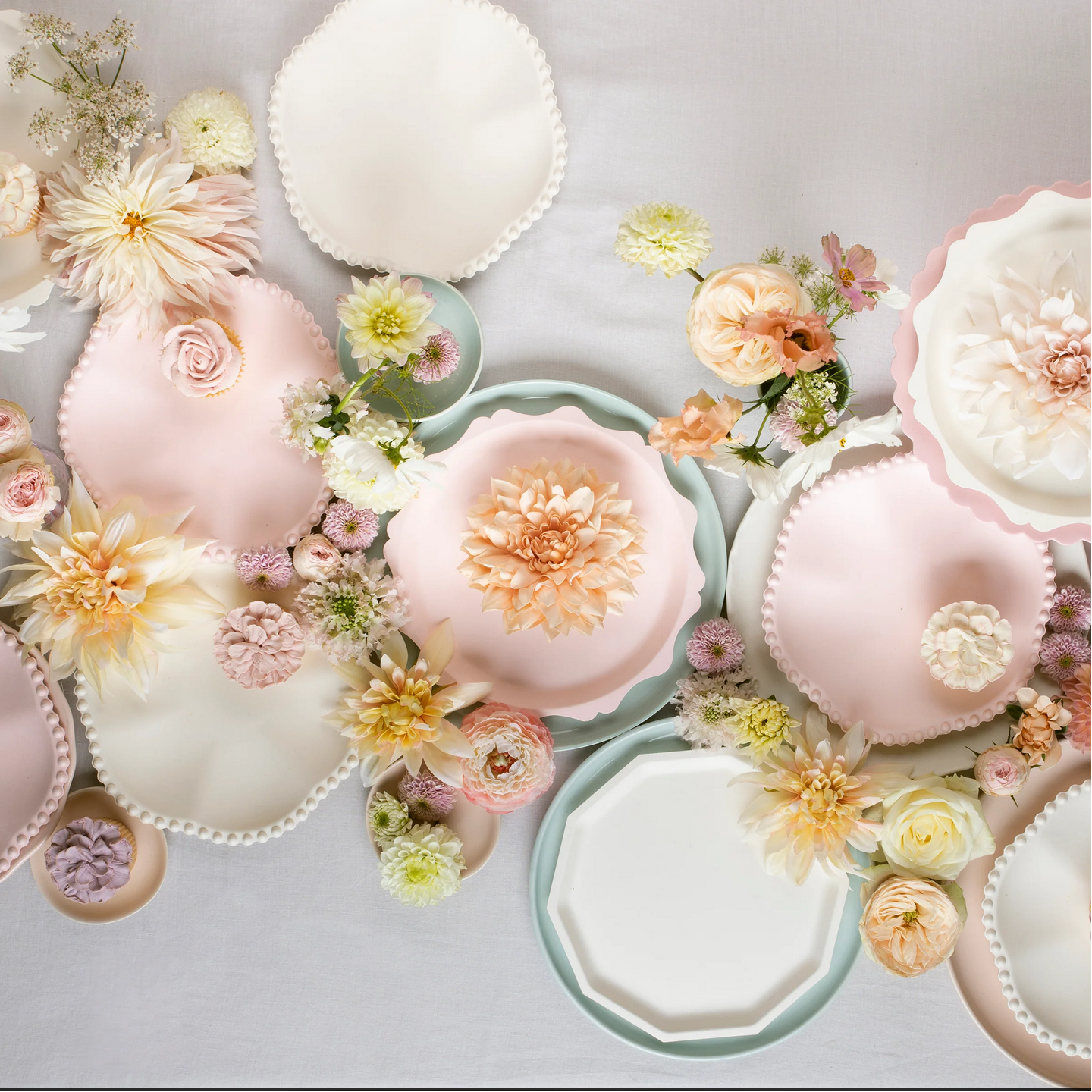 Decorative plates with floral arrangements on a light background
