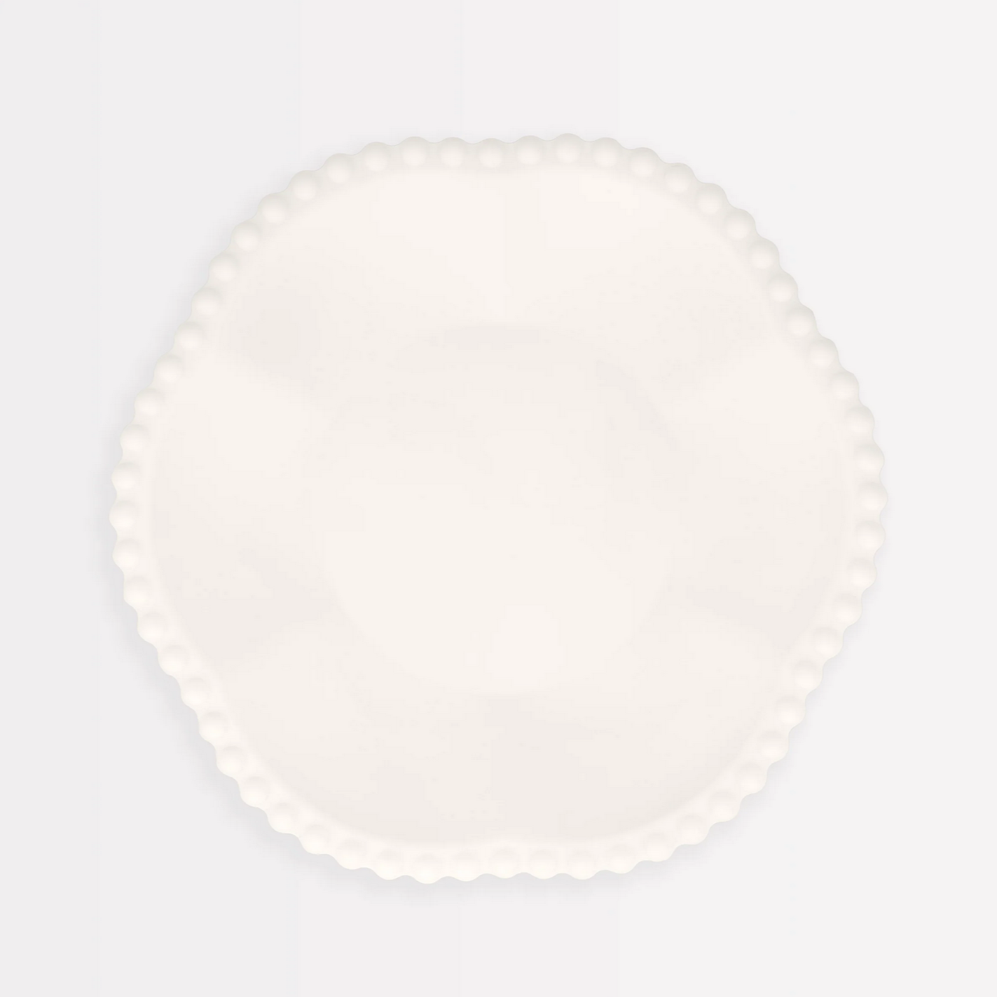 Round white plate on a light gray background