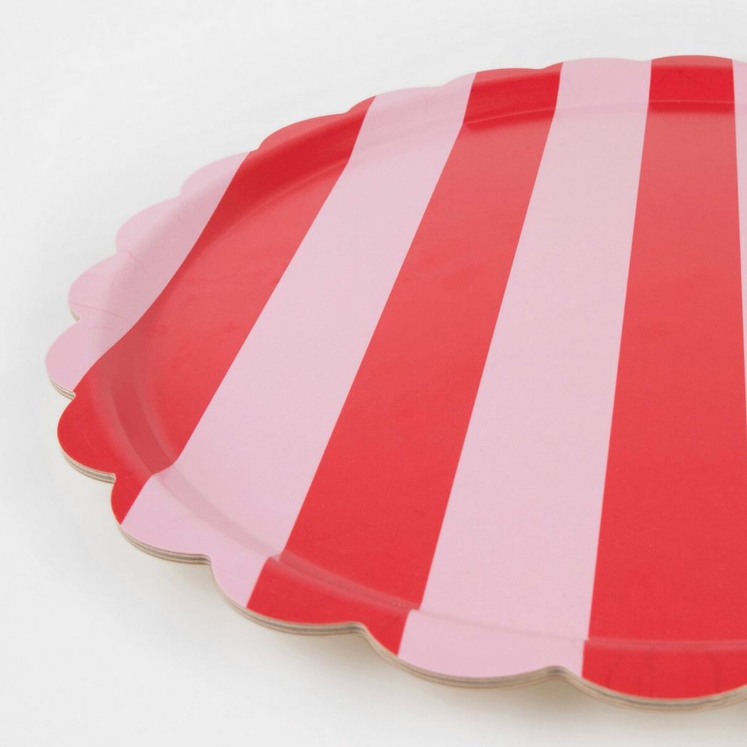 Set of red and pink striped paper plates on a white background