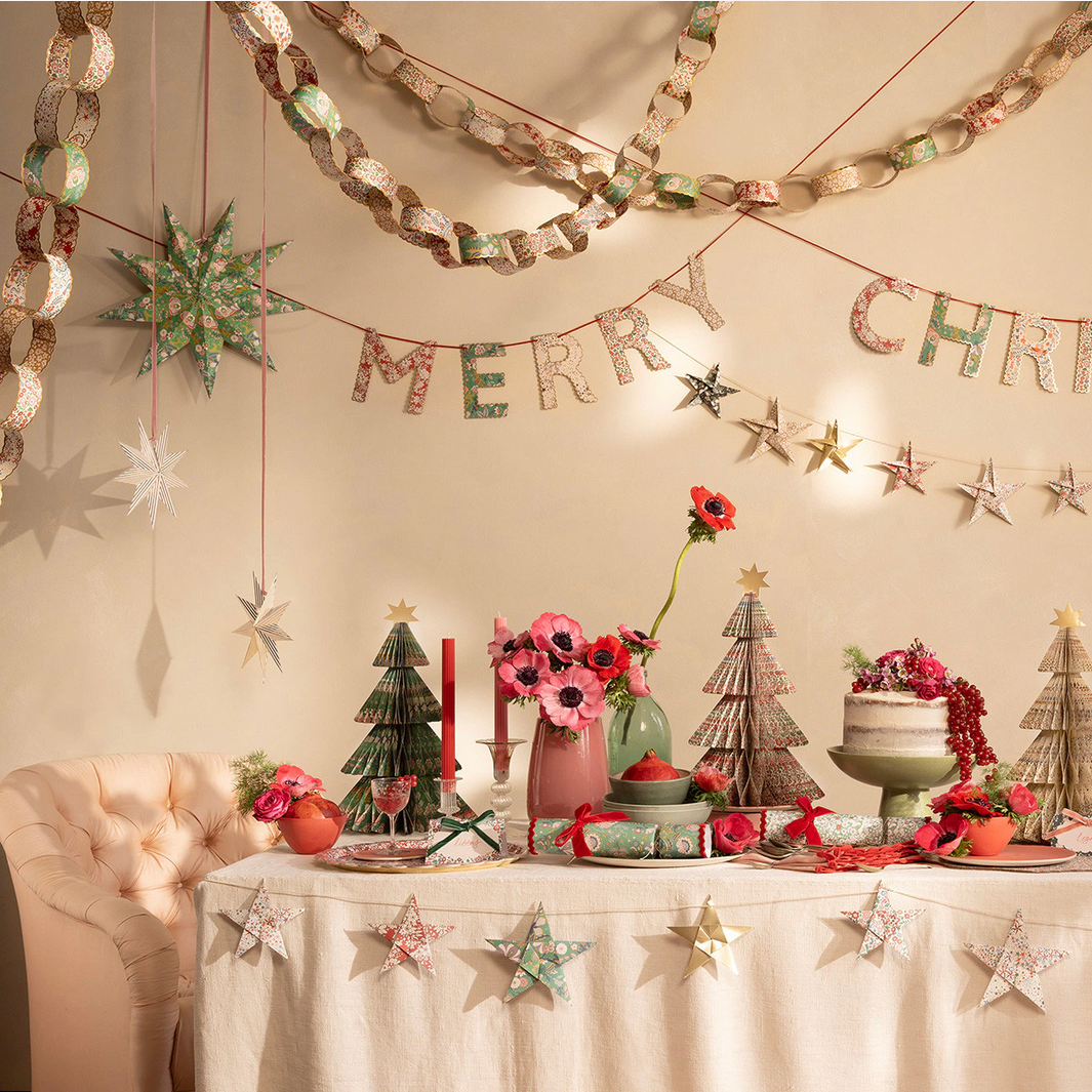 Decorated Christmas table with festive decorations and a 'Merry Christmas' banner.