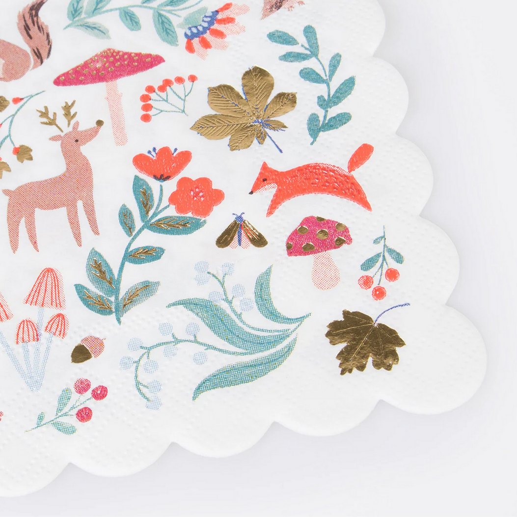 Decorative paper with nature-themed illustrations including deer, fox, flowers, and leaves on a white background.