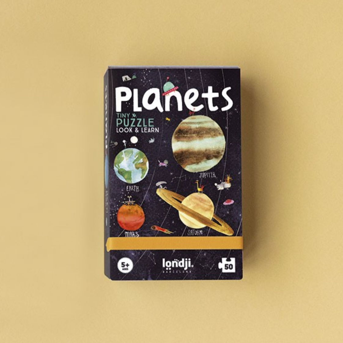 Children's puzzle box titled 'Planets' on a beige background