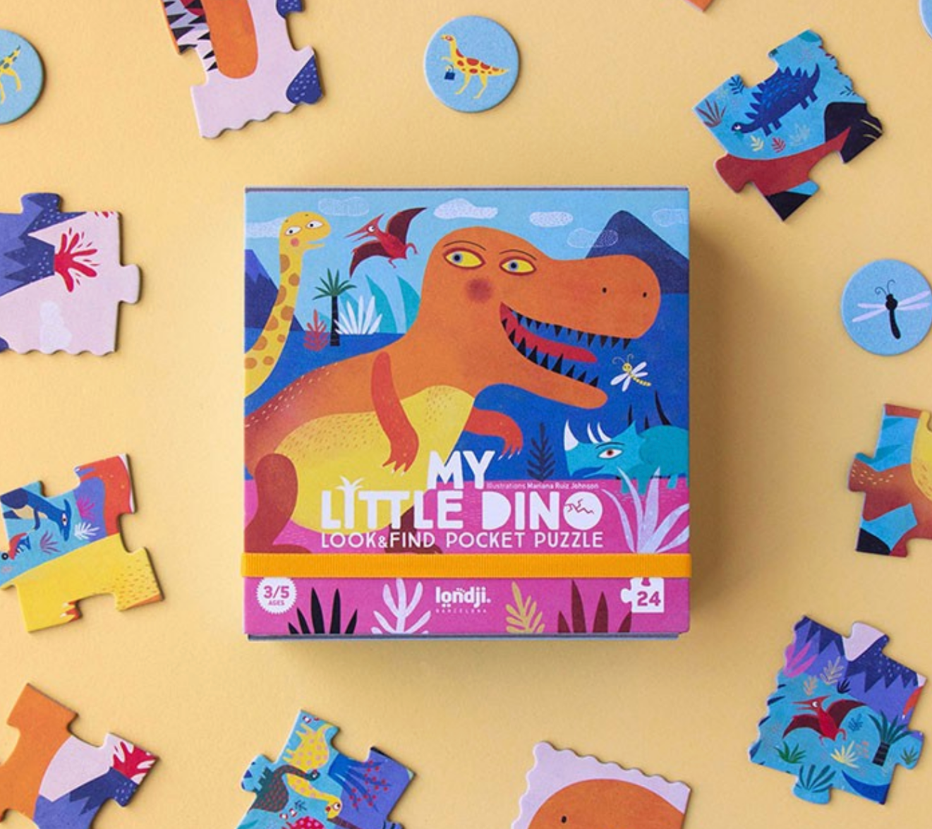 Children's dinosaur puzzle with pieces scattered on a yellow background