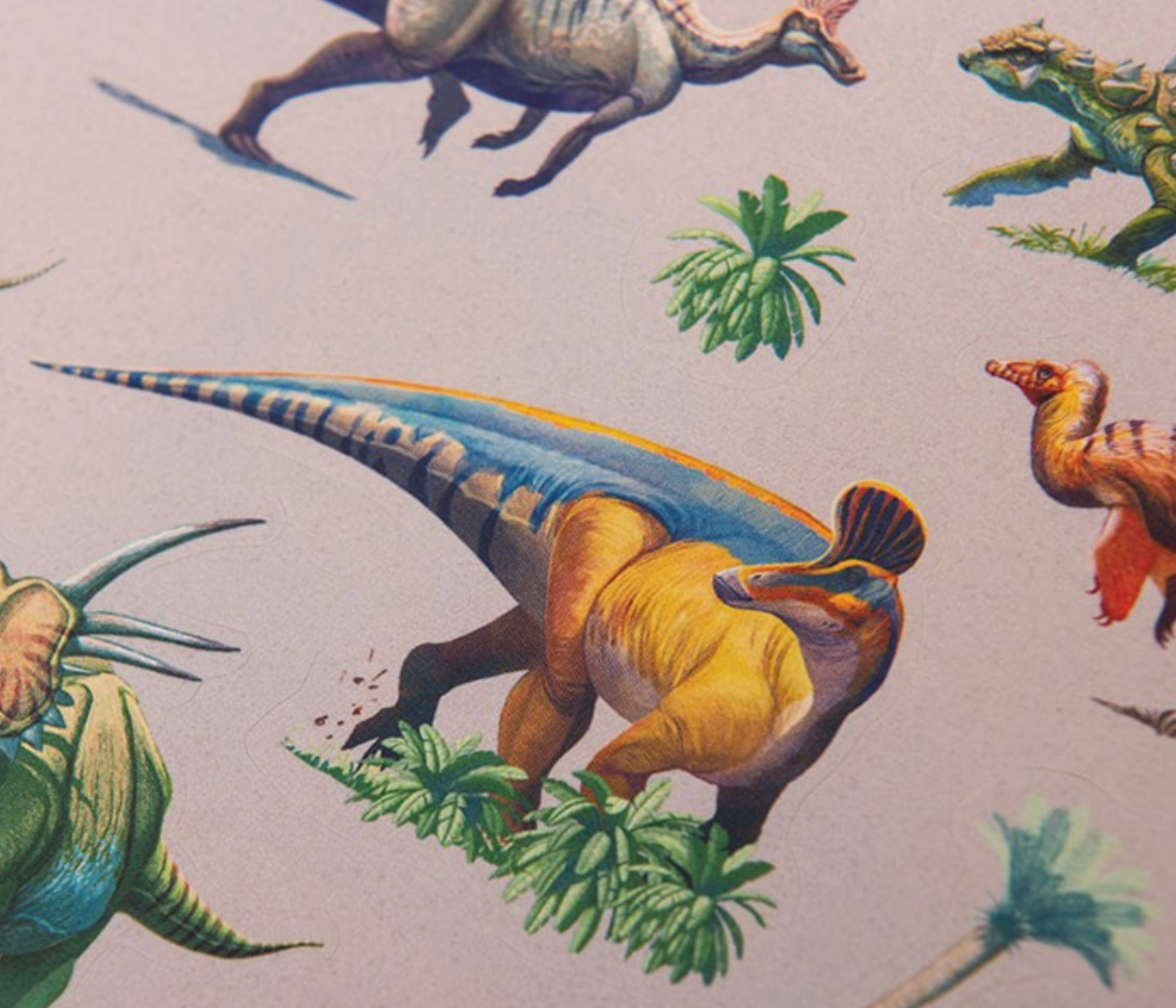 Pattern of colorful dinosaurs and plants on a fabric-like background