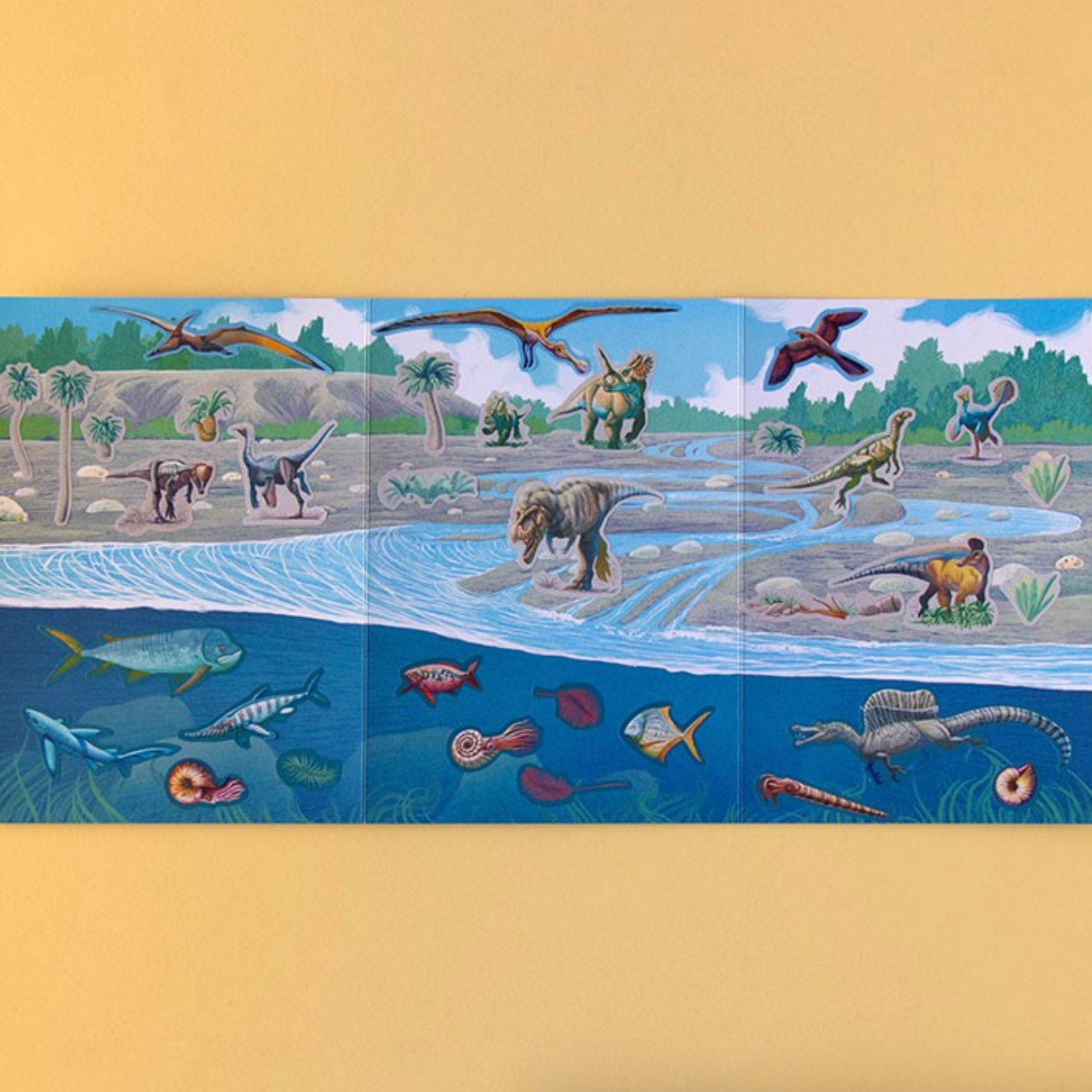 Educational children's book with illustrations of dinosaurs and underwater creatures on a yellow background.