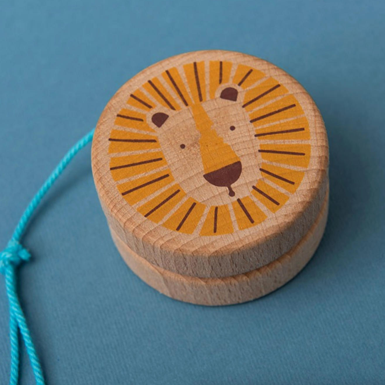 Wooden toy with lion design on a blue background