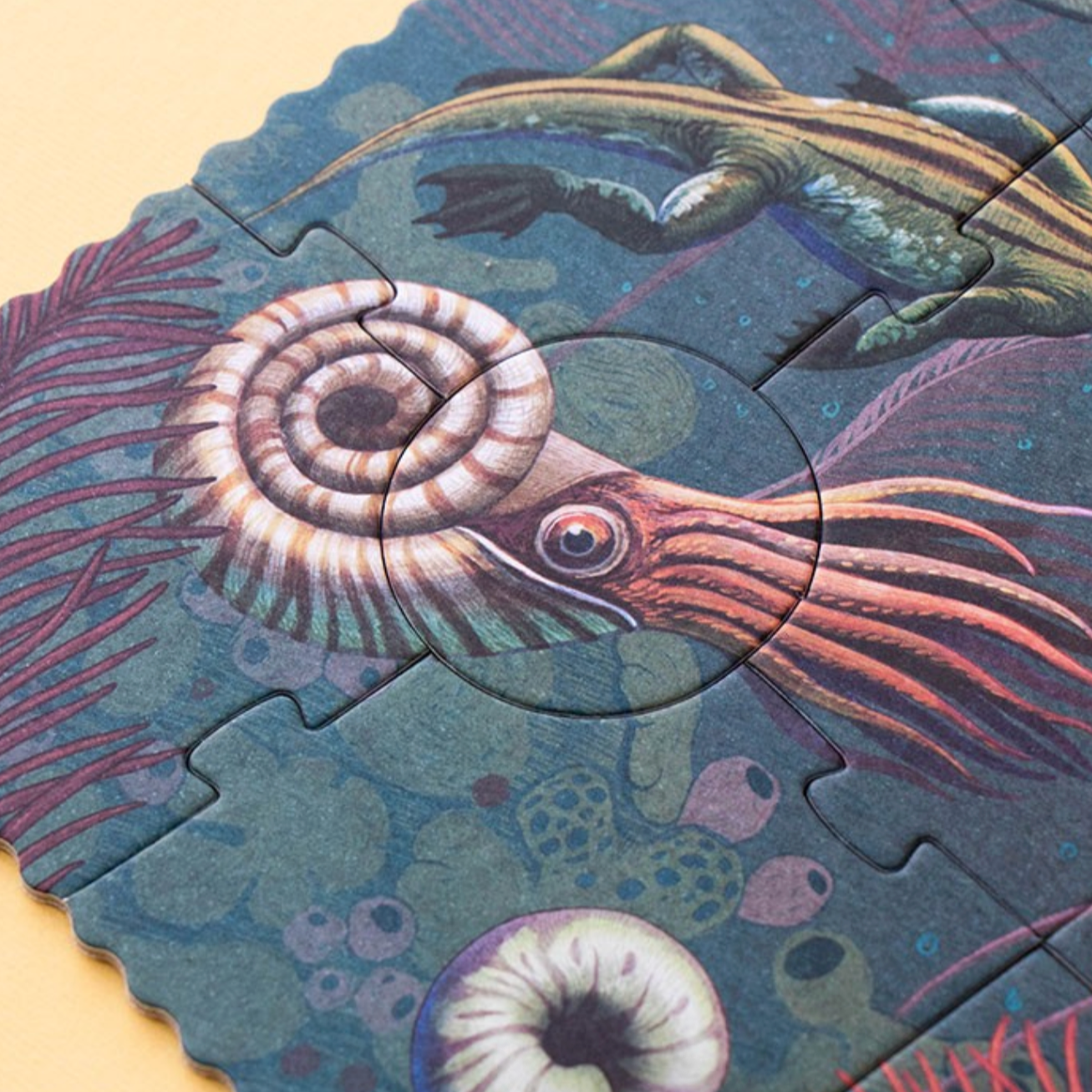 Jigsaw puzzle with a prehistoric sea creature design on a beige background