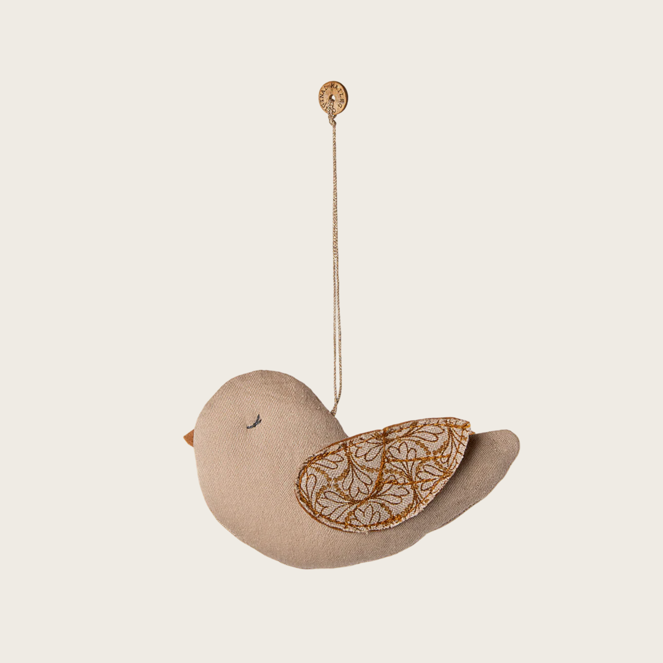 Decorative bird ornament with leaf pattern on a white background