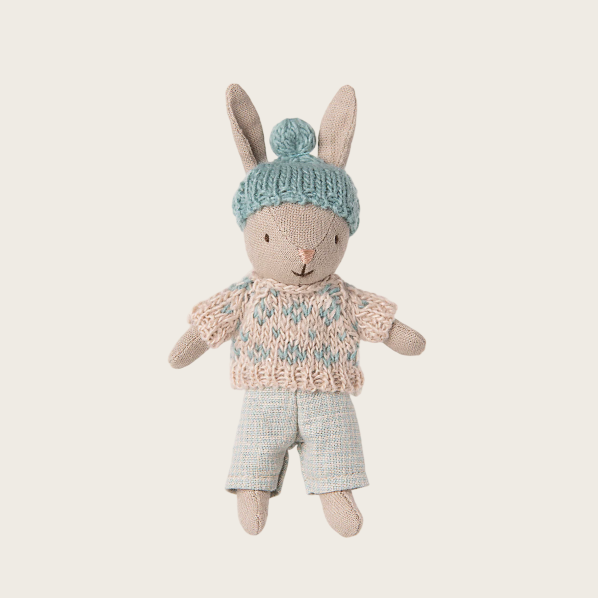 Stuffed rabbit toy with a blue knitted hat 