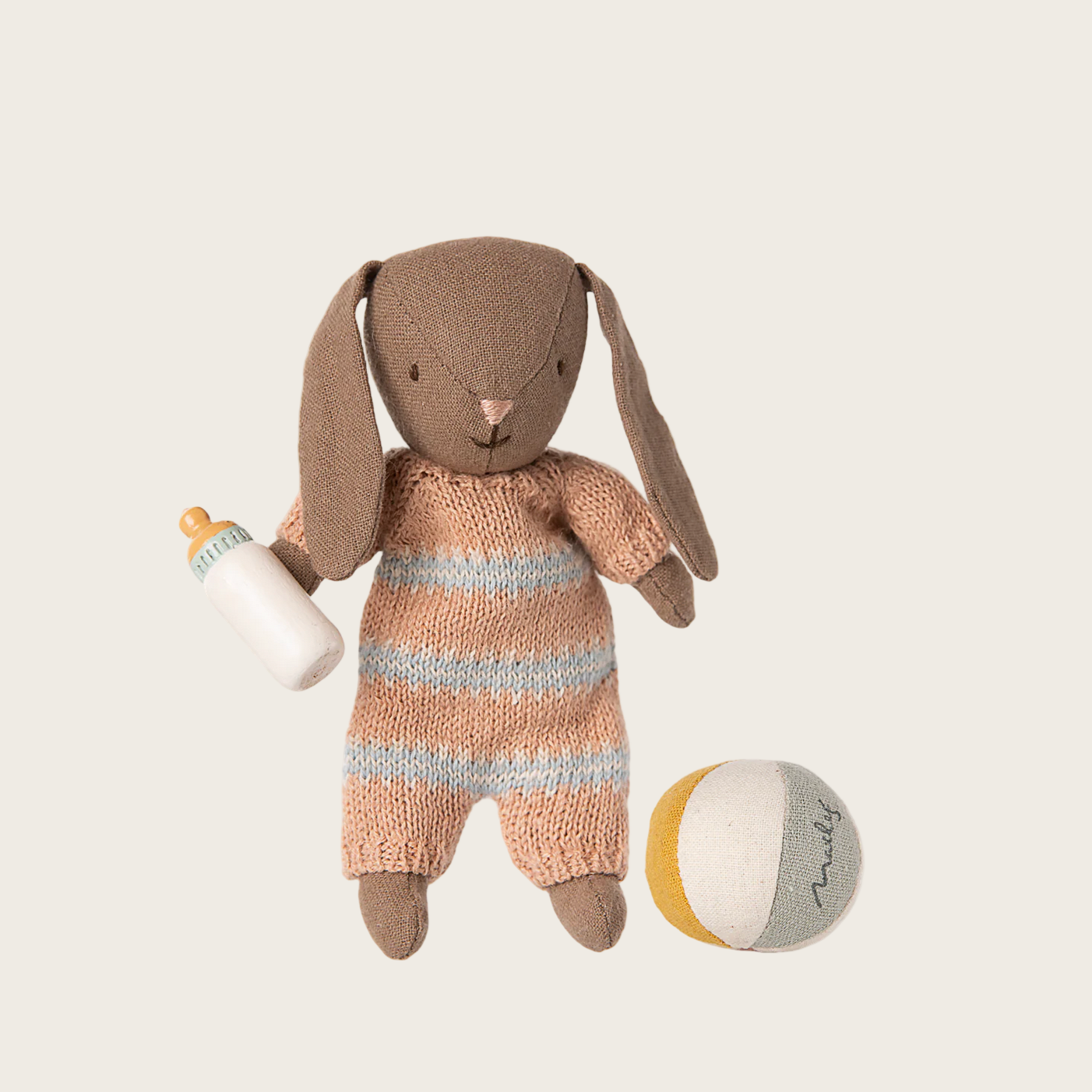 Toy rabbit in a knitted outfit with a bottle 