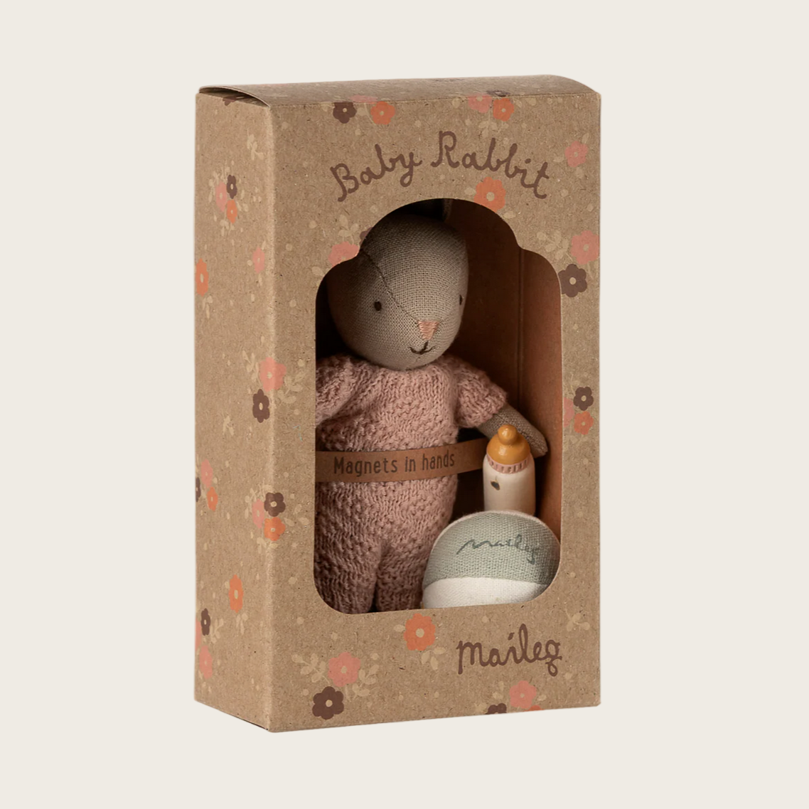 Toy rabbit in a cardboard box with 'maileg' branding on a website page.