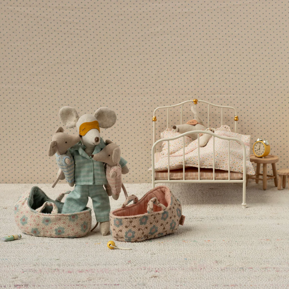 Children's room with toys and a bed in a neutral setting