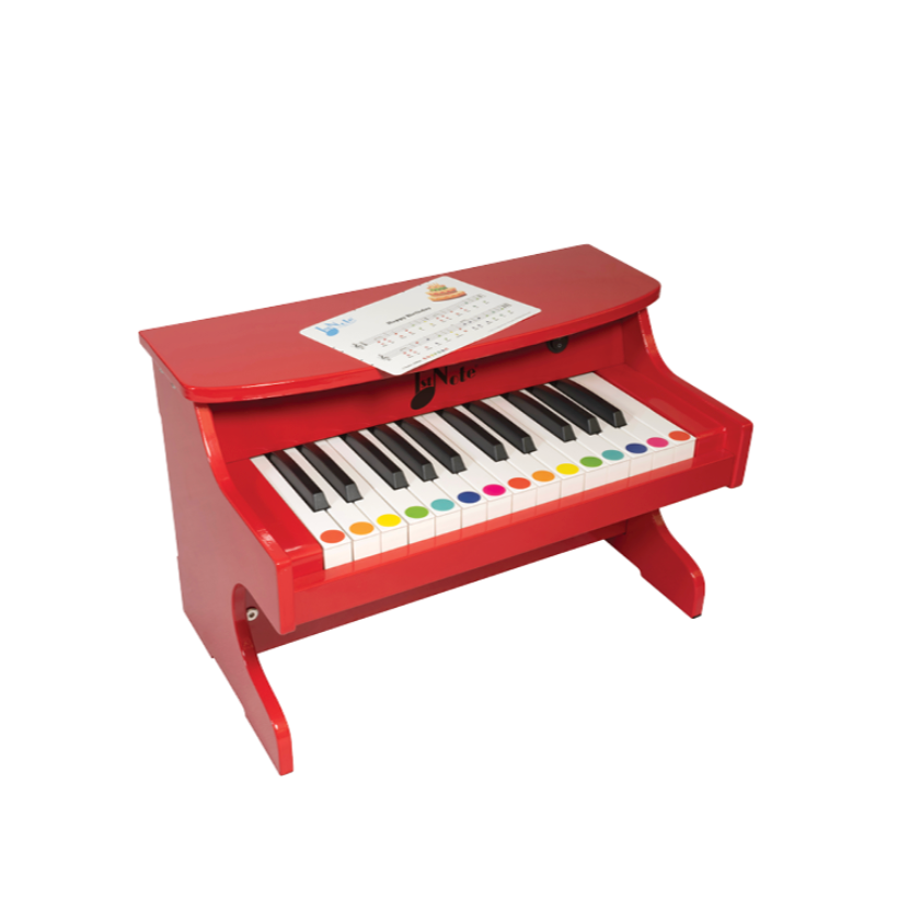 Red toy piano with colorful keys on a white background
