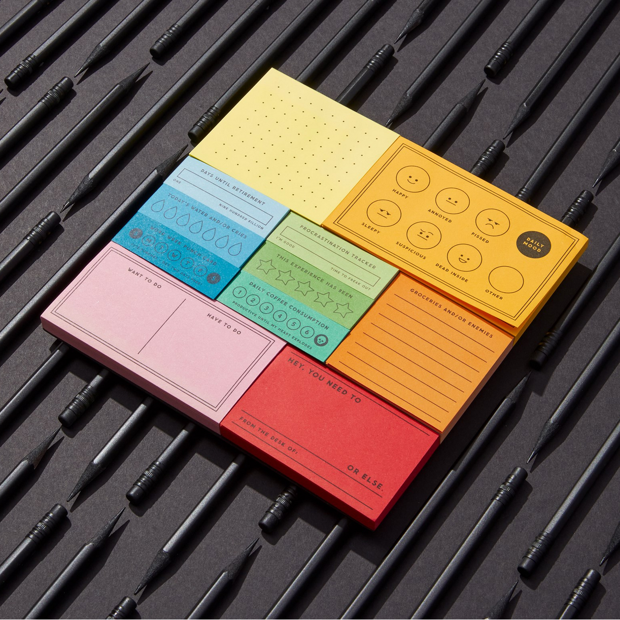 Colorful sticky notes with different designs on a black textured surface