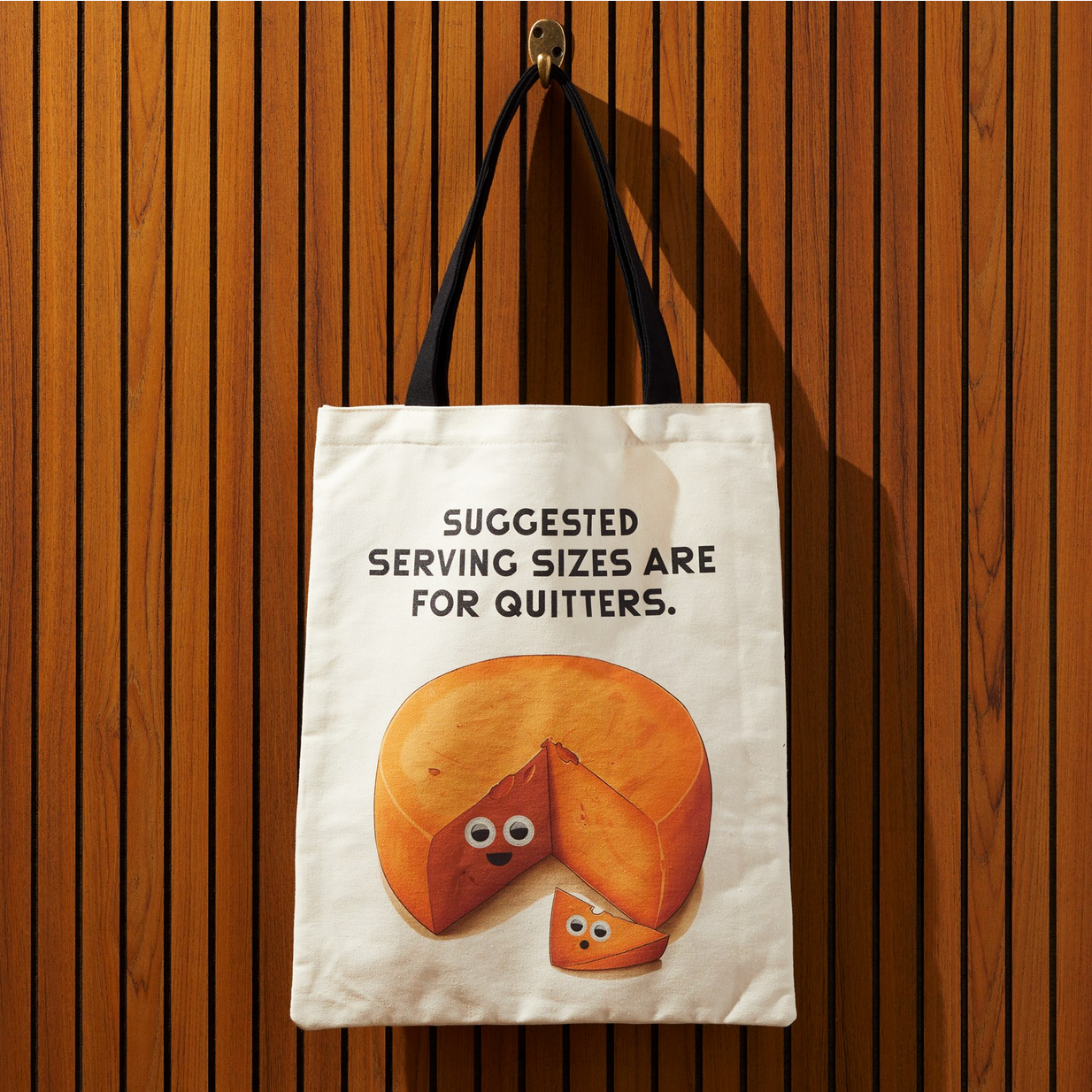 Tote bag with a pie design and humorous text on a wooden background