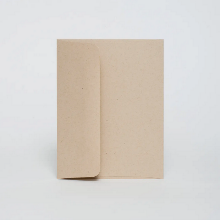 Two beige notebooks stacked on a white background