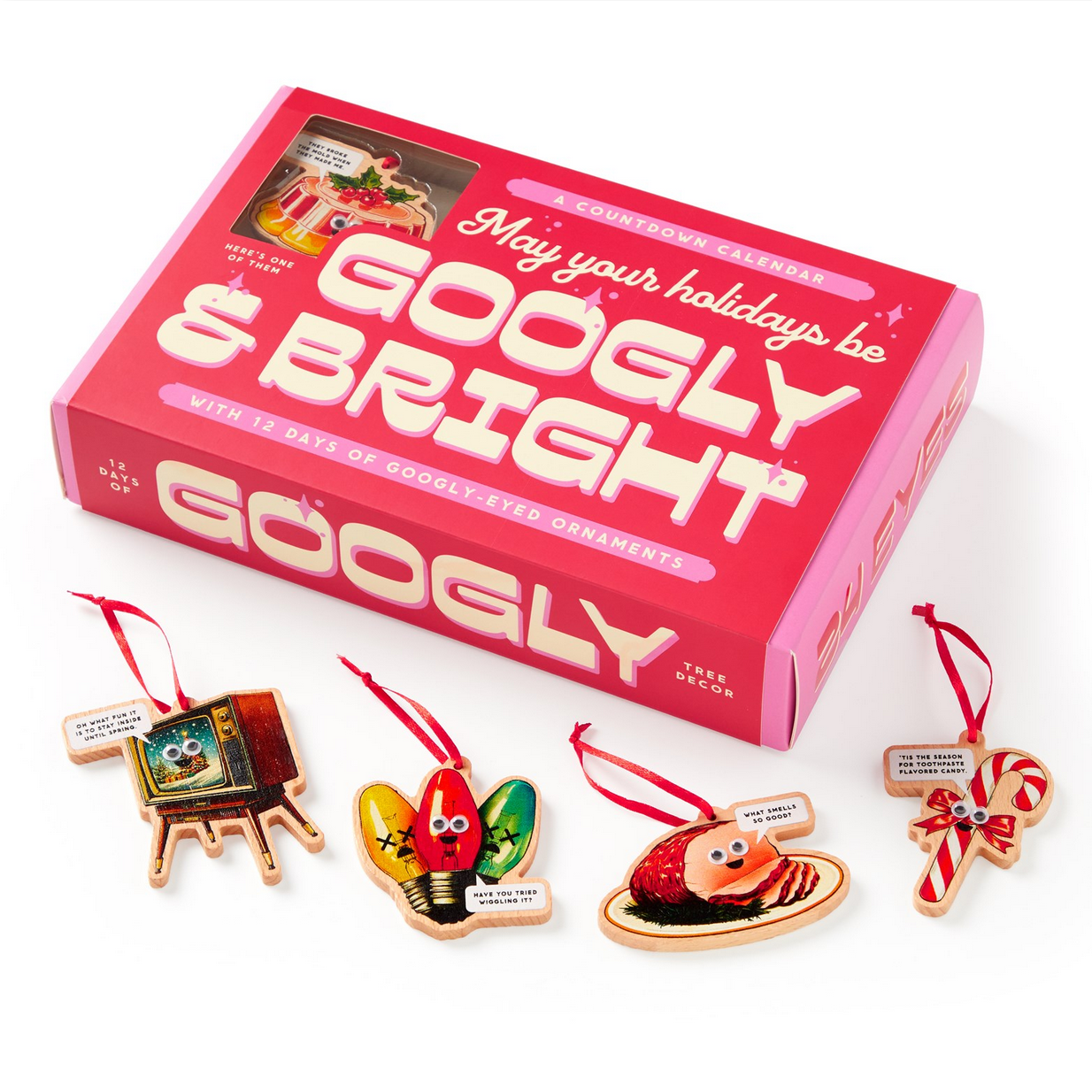 Box of Googly eye ornaments with decorative items on a white background