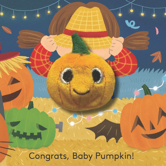 Illustration of a baby pumpkin with a straw hat surrounded by jack-o'-lanterns and festive lights.