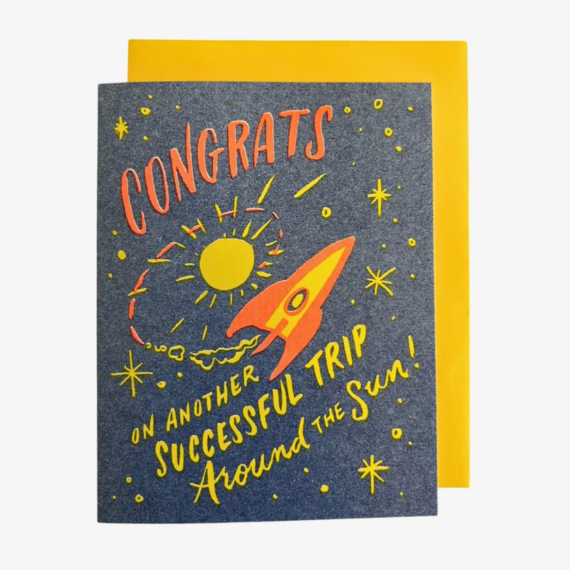 Greeting card with a rocket and sun design, featuring the text 'Congrats on another successful trip around the sun'.