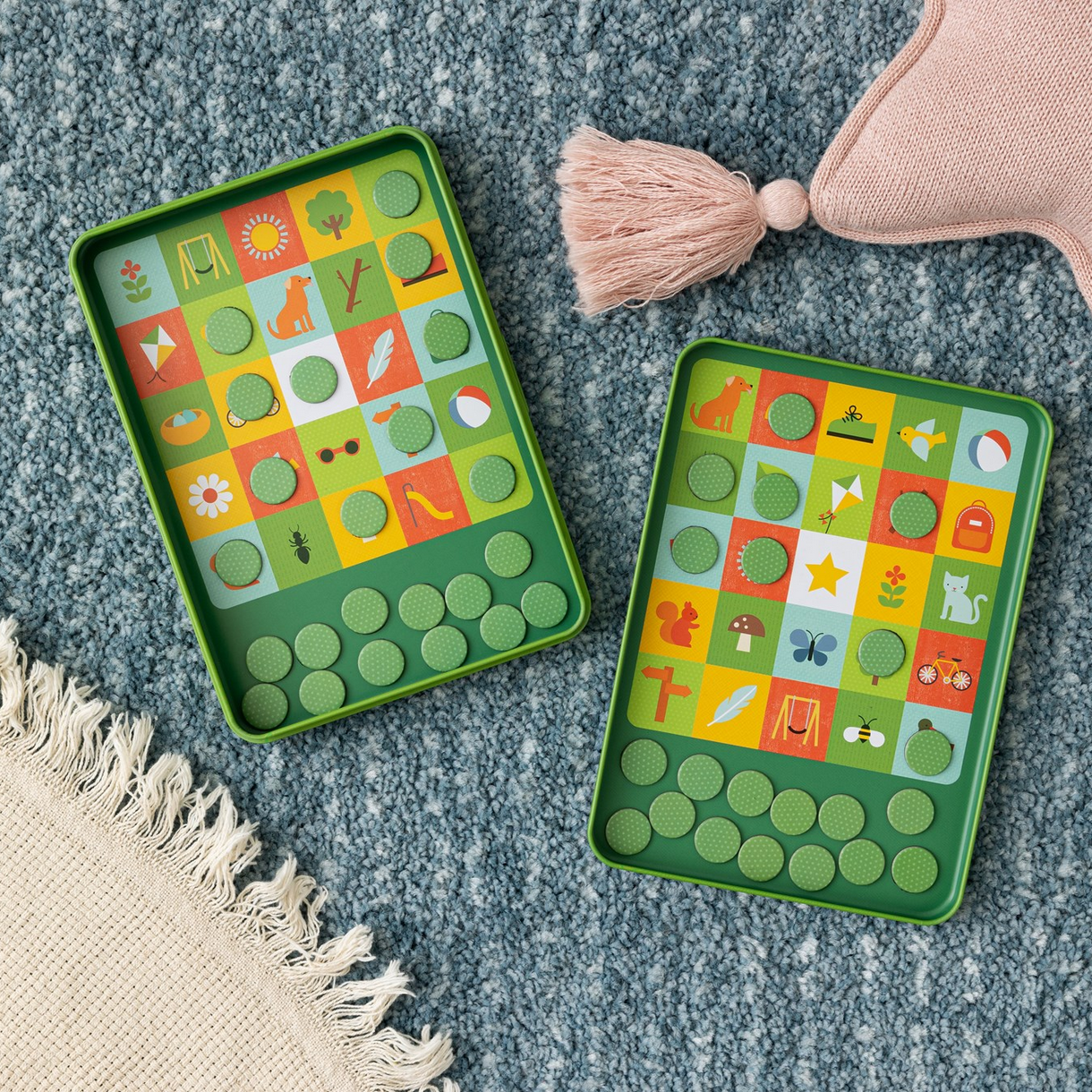 Two green educational toys with colorful patterns on a textured surface.