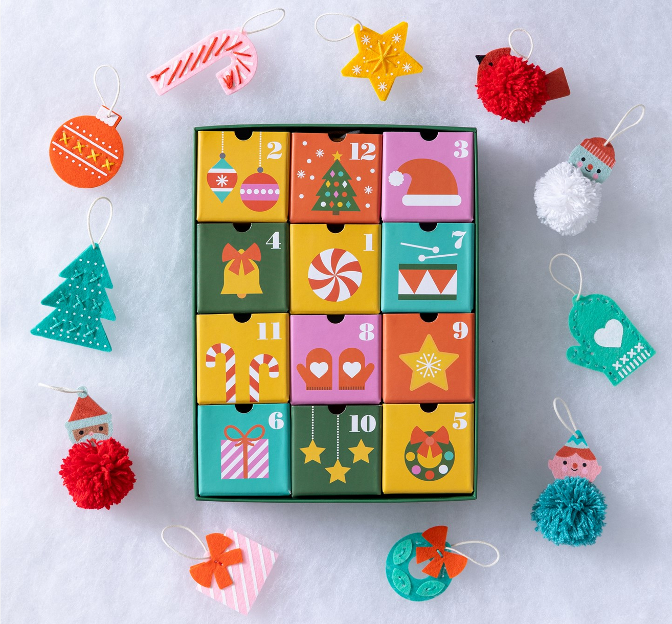 Colorful advent calendar with Christmas-themed decorations on a light background